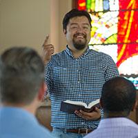 A man reading from the Bible in Good Shepherd Chapel